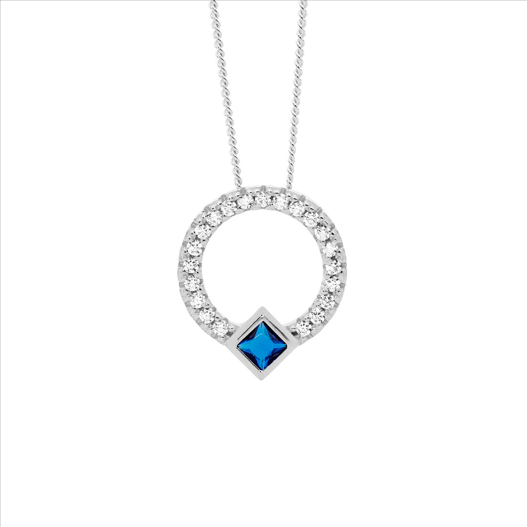 SS WH CZ 13mm Open Circle Pendant w/DK Blue CZ Princess Cut Bezel Set